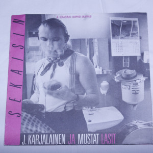 J. Karjalainen ja mustat lasit Sekaisin
